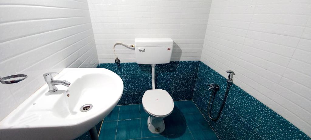 a bathroom with a sink and a toilet at iSTAYS - Loop Road, Yercaud in Yercaud
