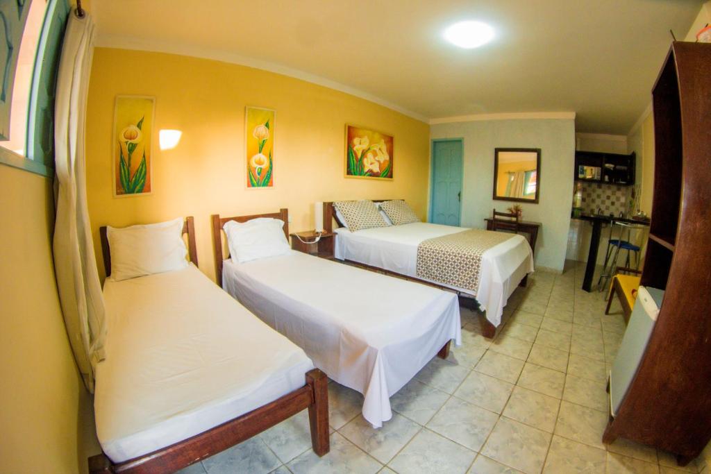 A bed or beds in a room at Pousada Lazer do Sol