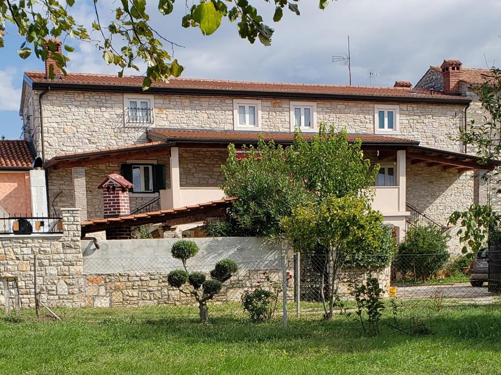 uma casa com uma parede de pedra em frente em Villa Kortina em Basanija