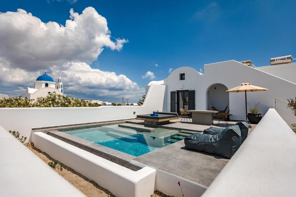 a villa with a swimming pool and a house at Vineyard Exclusive Suites in Akrotiri