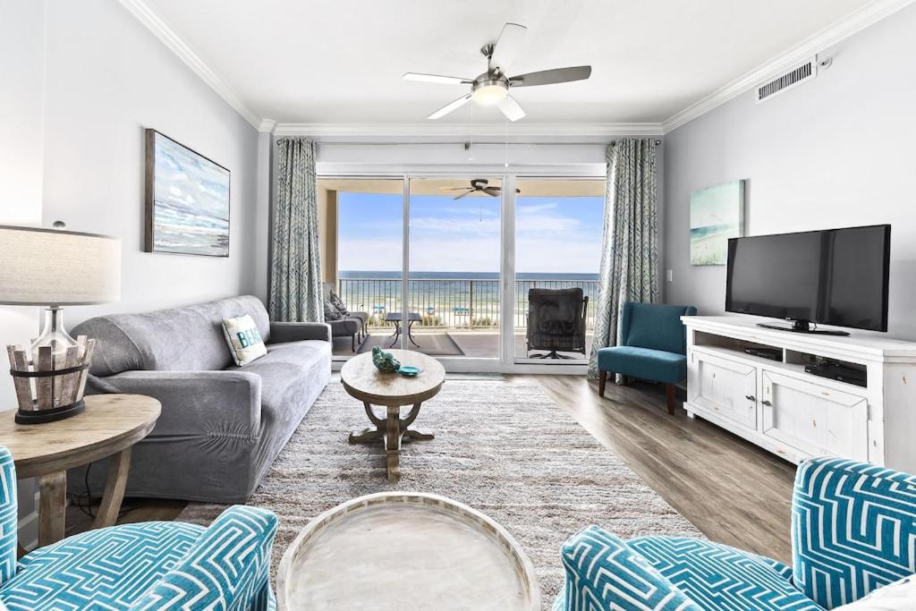 a living room with a couch and a tv at Regency Isle Unit 307 in Orange Beach