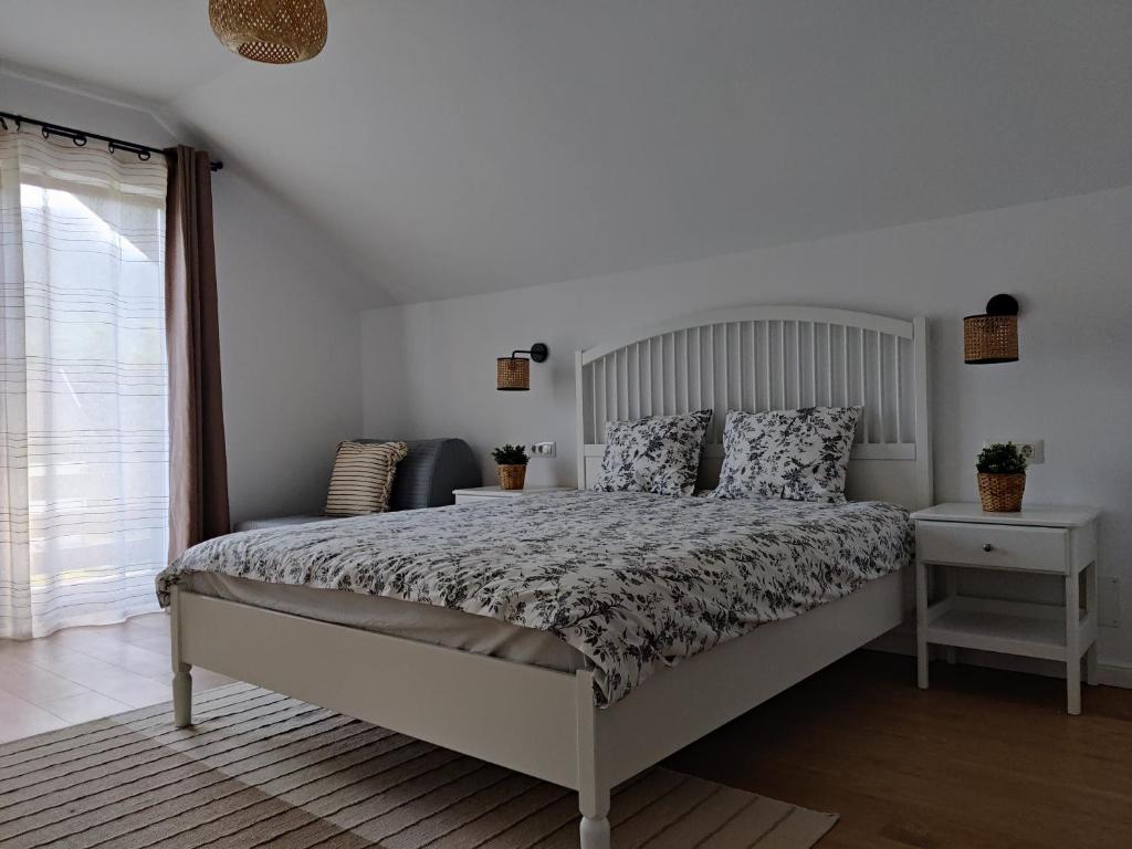 a bedroom with a large bed and a window at Ara Chalet in Bran