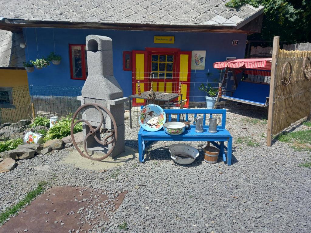 a colorful house with a table in front of it at Modra Farma in Pliešovce