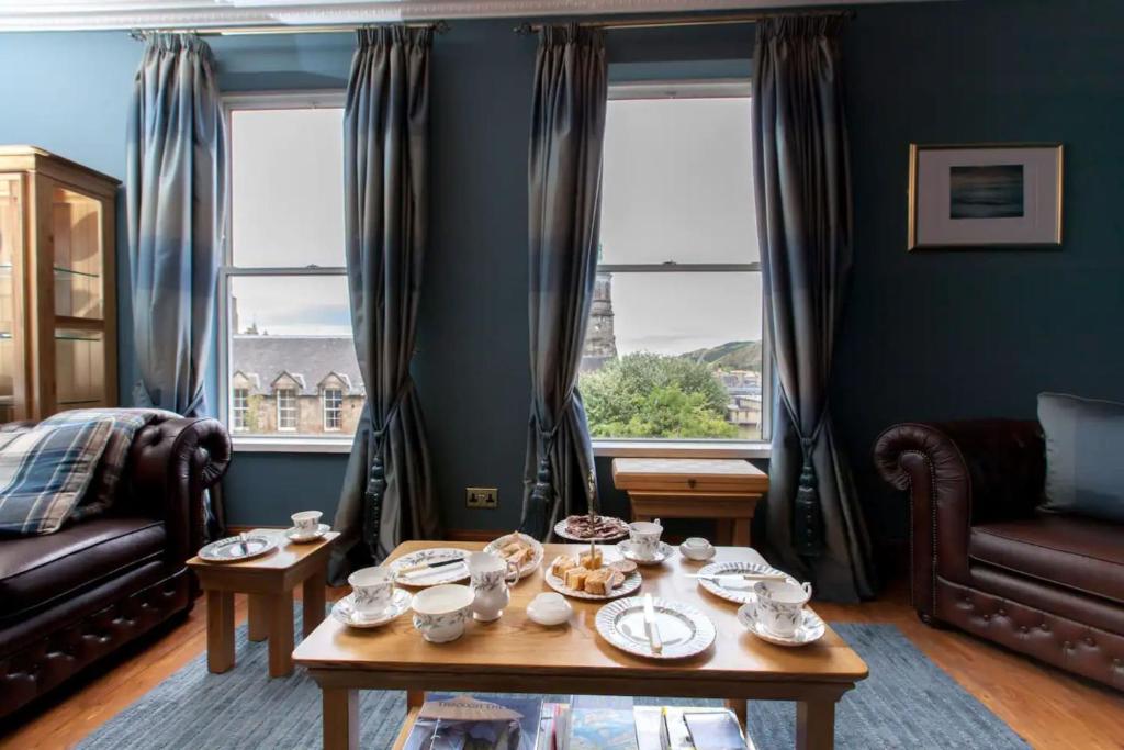 a living room with a table with dishes on it at Blackfriars Residence - Beautiful Home in Edinburgh