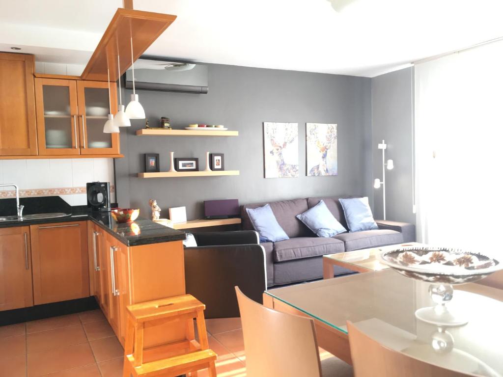 a kitchen and living room with a couch and a table at Torrox Boutique Apartaments - Paraiso Sol in Torrox Costa