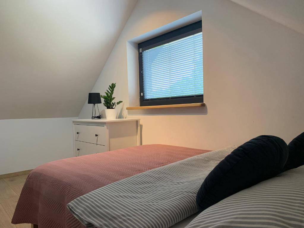 a bedroom with a bed and a window at Domki na odludziu in Kazimierz Dolny