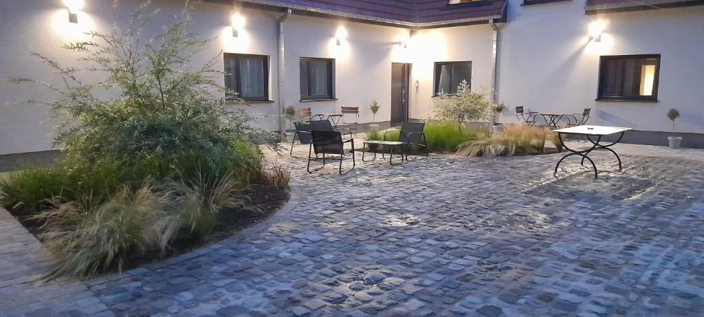 a patio with chairs and tables in a building at Côté Grange in Tournai