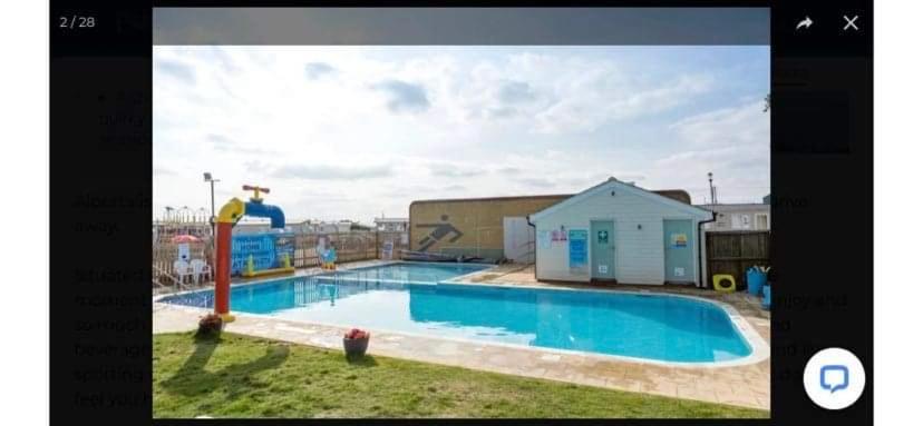 a large swimming pool with a water slide at Alberta holiday park in Whitstable