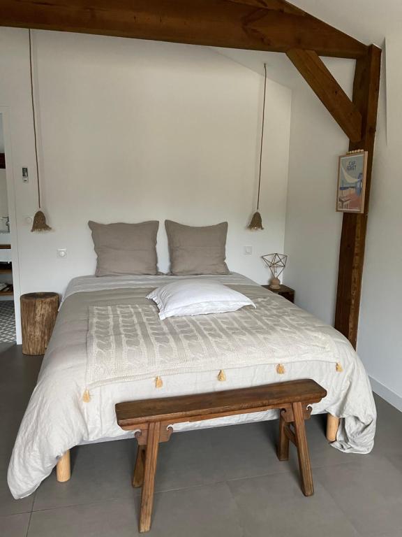 a bedroom with a large bed with a wooden frame at OSTAL 158 in Le Barp