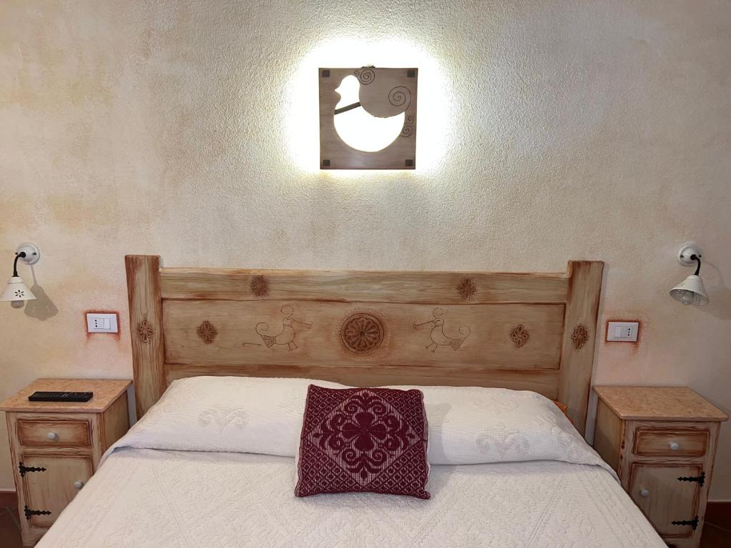 a bedroom with a bed with a pillow on it at Canne al Vento in Galtellì