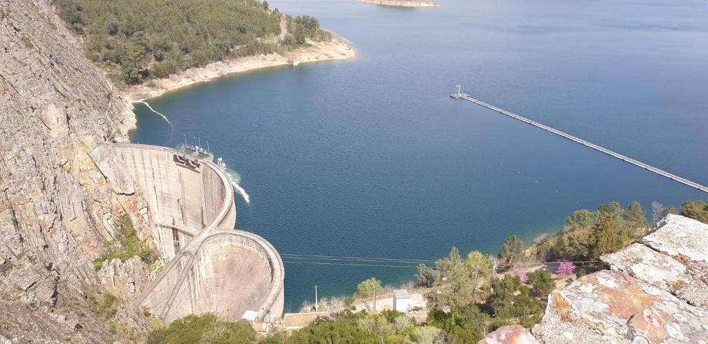 a roller coaster on a mountain next to a body of water at Casa Rural "Casa da Professora" - Meãs, Pampilhosa da Serra in Pampilhosa da Serra