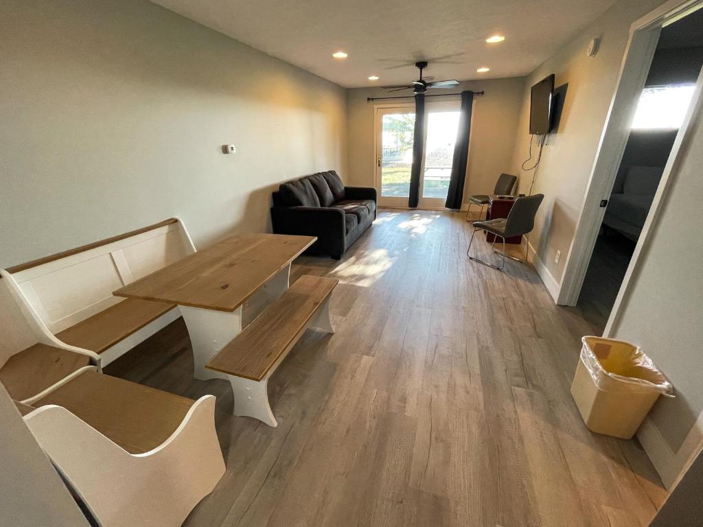 a living room with a table and a couch at Lake Bluff Inn and Suites in South Haven