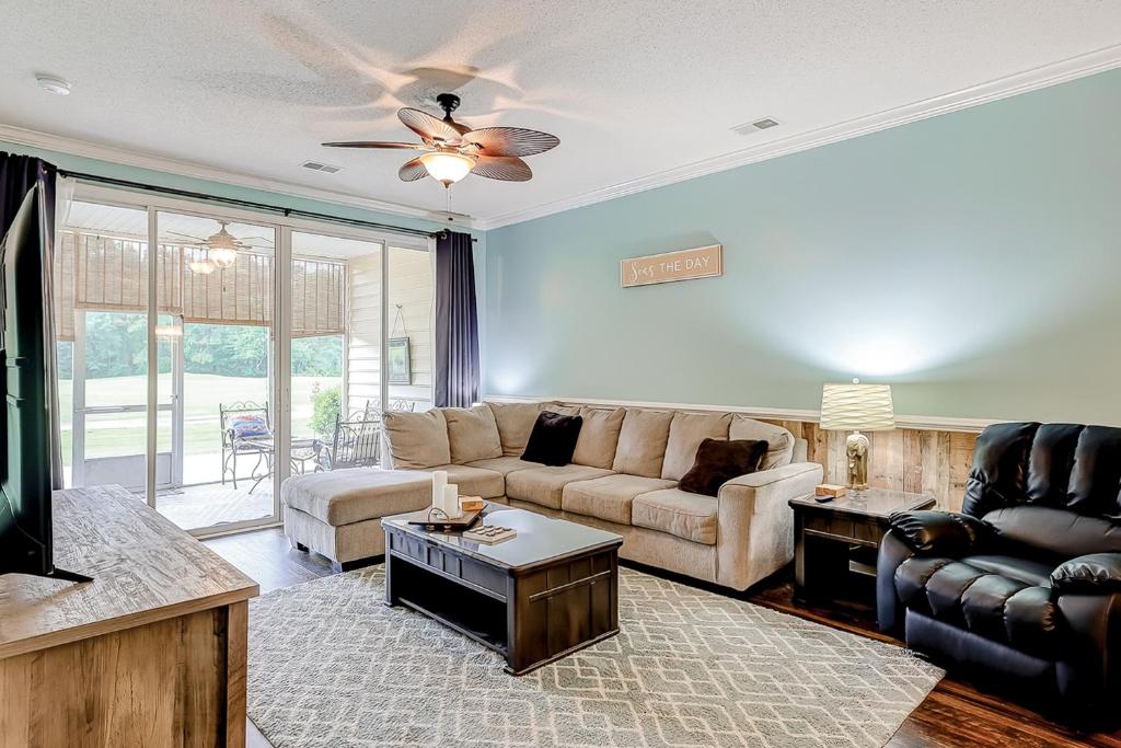 a living room with a couch and a tv at Legends Resort - Montrose Ln - C in Myrtle Beach