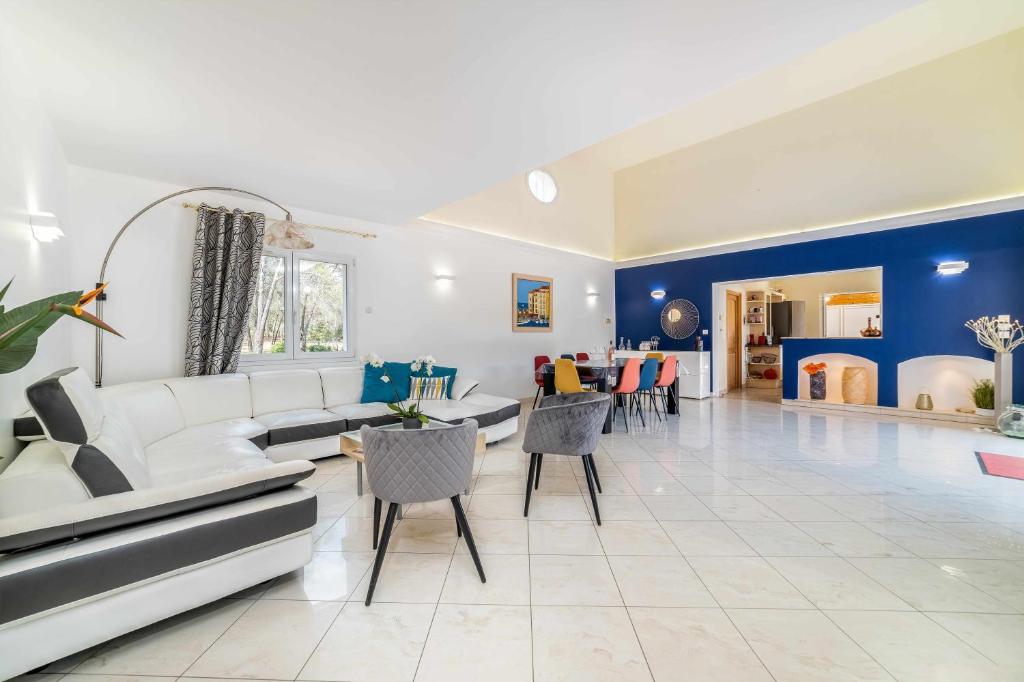 a living room with a white couch and blue walls at Villa located between Cannes and SaintTropez in Puget-sur Argens
