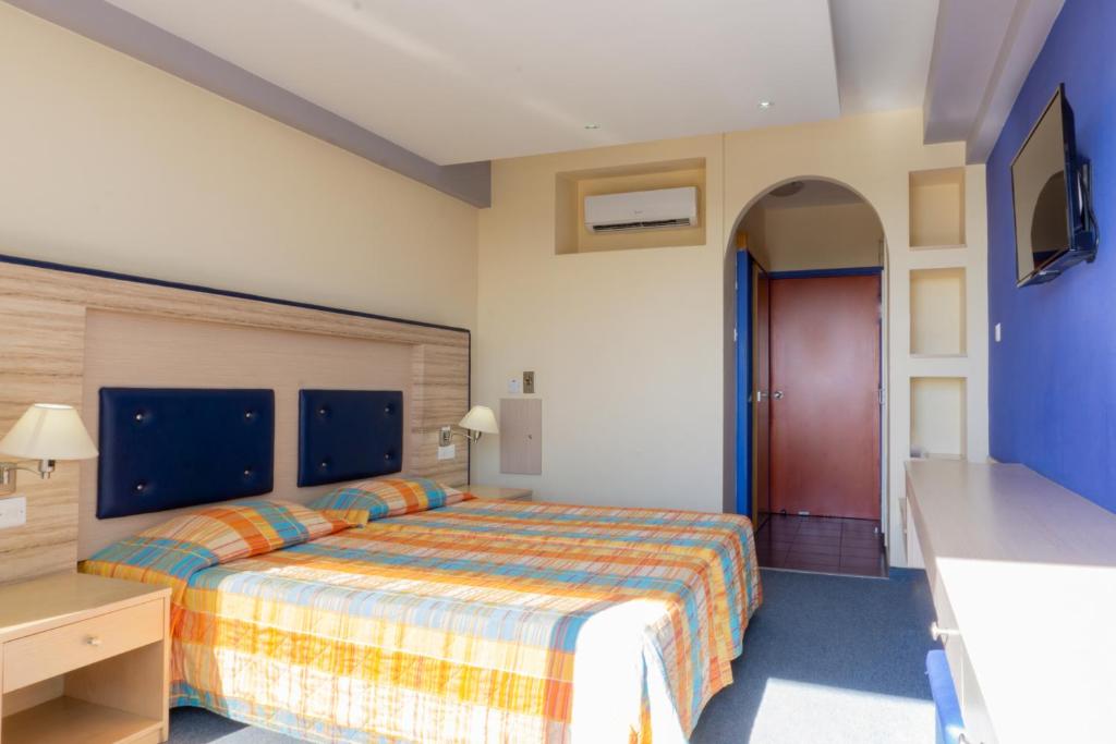 Postel nebo postele na pokoji v ubytování Mariandy Hotel