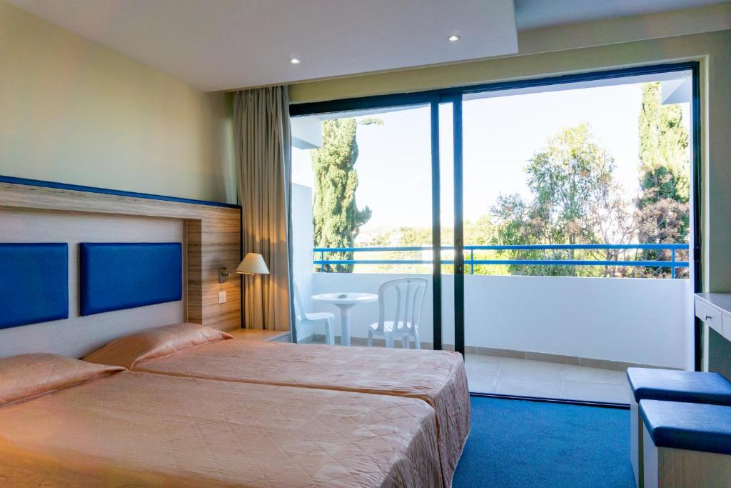 Postel nebo postele na pokoji v ubytování Mariandy Hotel