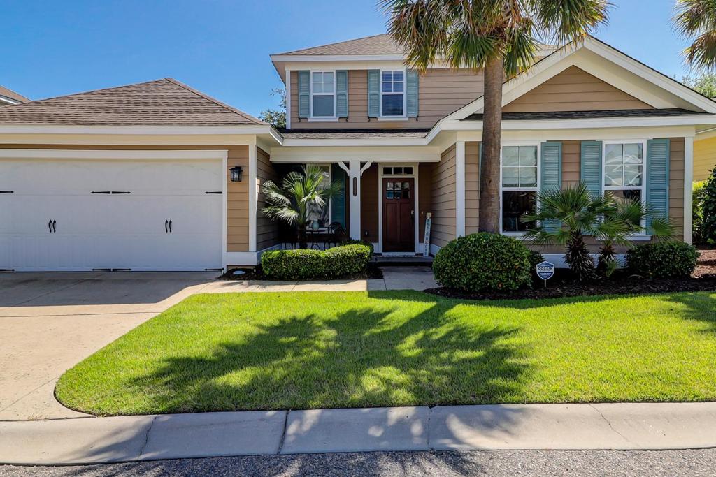 a house with a palm tree and a driveway at North Beach Coastal Breeze in Myrtle Beach