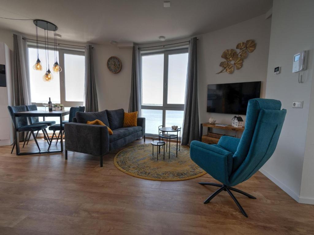 a living room with a couch and chairs and a table at Premium apartment in Scherpenisse with roofed terrace in Scherpenisse