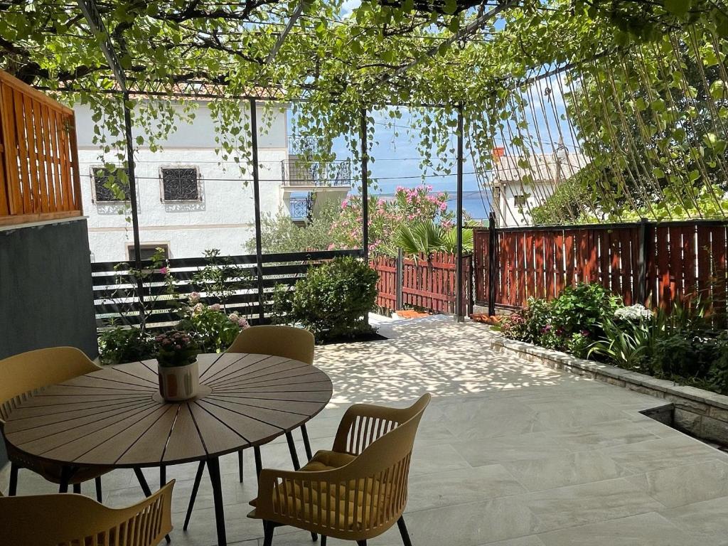 a patio with a table and chairs and a fence at Mediterra 2 in Crikvenica