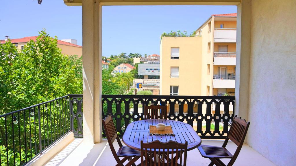 une table bleue et des chaises sur un balcon dans l'établissement Appartement 1 chambre avec Terrasse, Rue Pons, By Palmazur Vacances, à Cannes