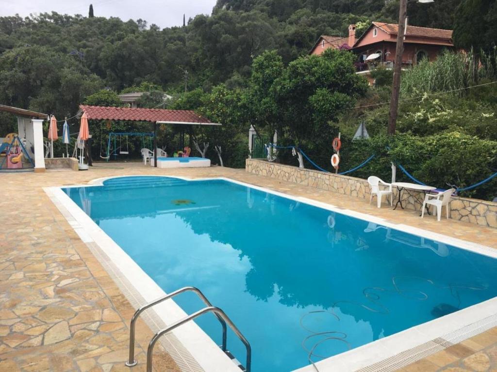 a large blue swimming pool in a resort at Apartment in Mpenitses with Sea Views & Pool in Benitses