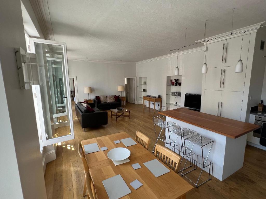 a kitchen and living room with a table and a kitchen and a living room at Centrally located 1-Bed apartment in Inverness in Inverness