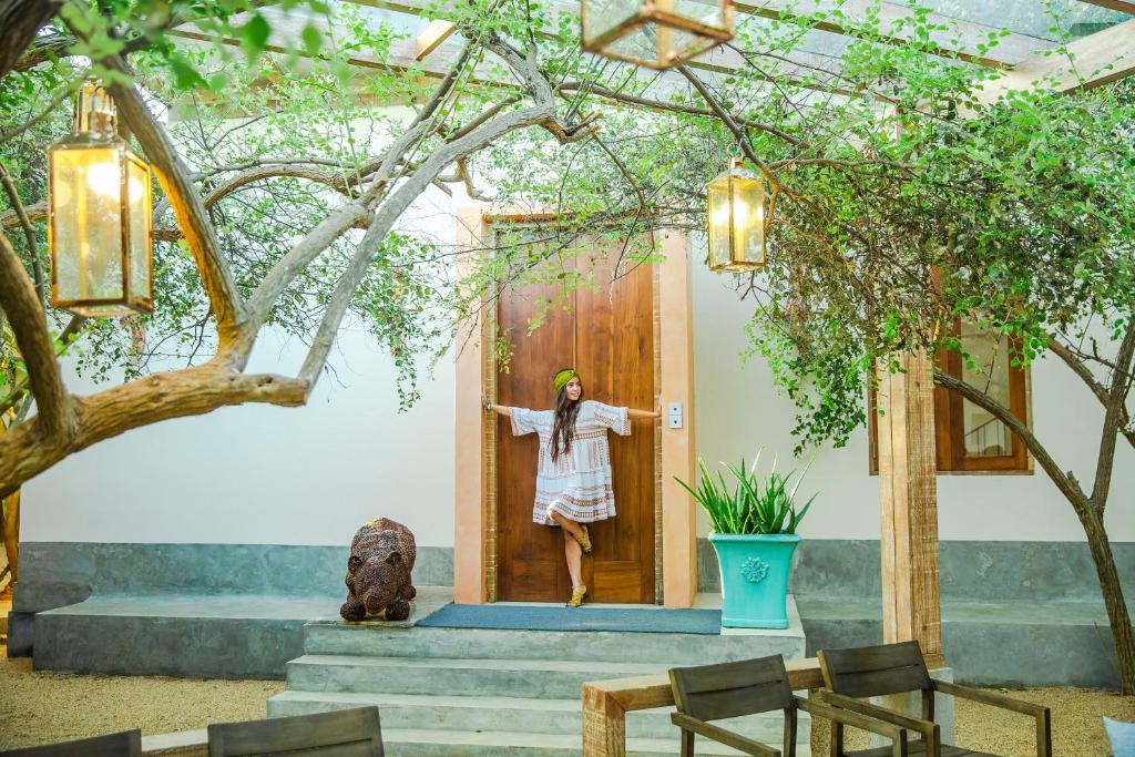 a woman standing in the door of a house at O2 Villas Yala in Yala