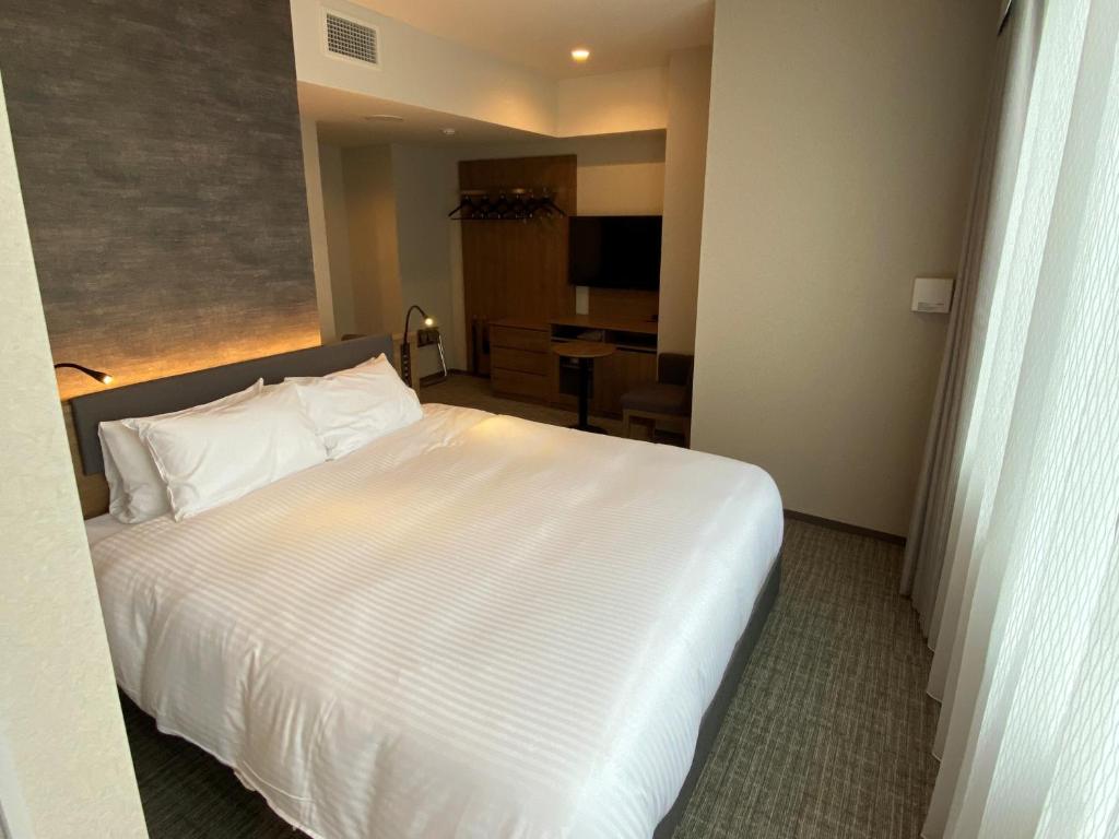 Postel nebo postele na pokoji v ubytování Hotel Rilassare Tokyo