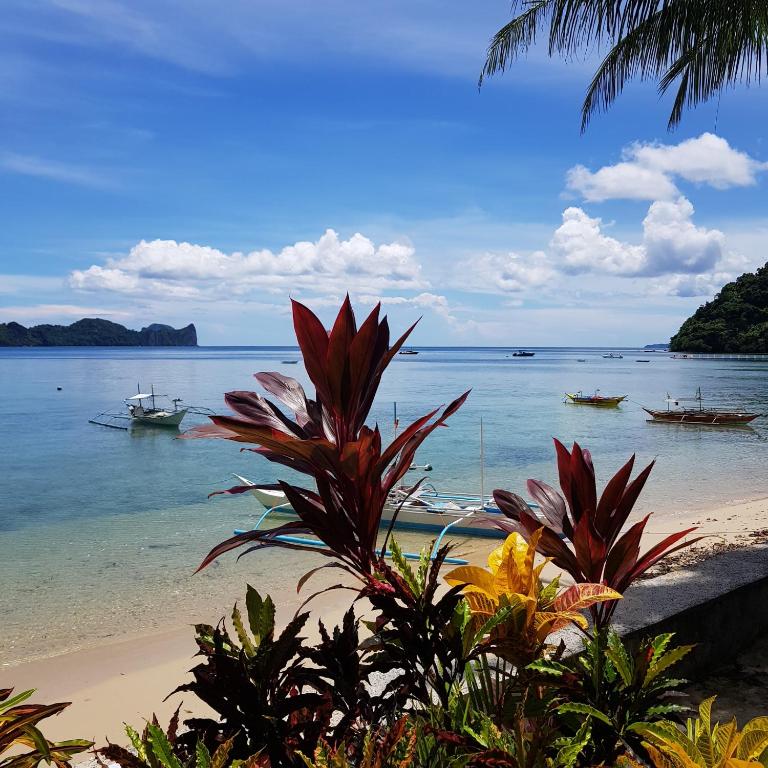 a view of a beach with boats in the water at Golden Monkey Beach Hotel in El Nido