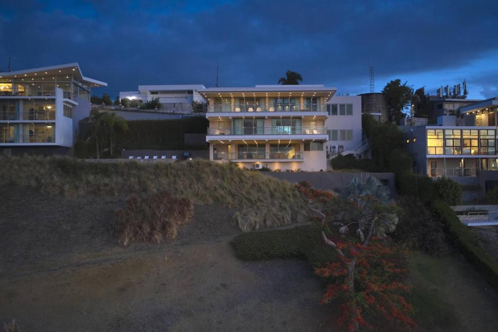 a building on a hill at night with lights at Happy Days Villa B in Fajardo