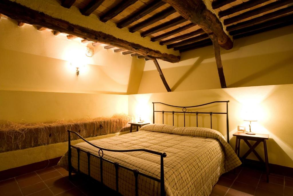Postel nebo postele na pokoji v ubytování Antico Borgo Poggiarello