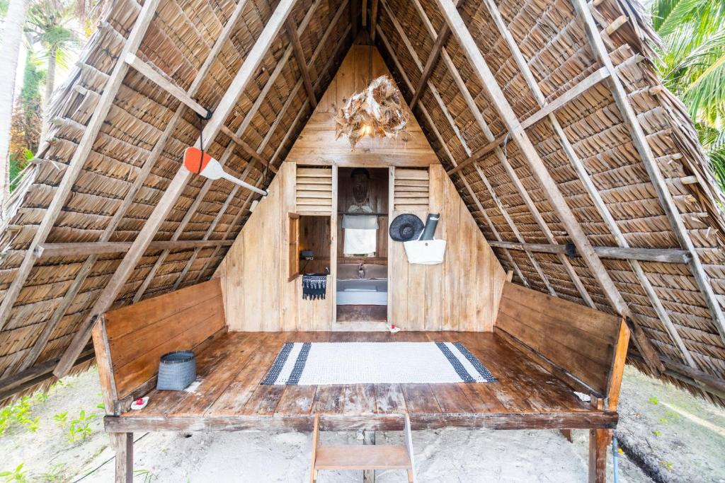 a room with a bench and a thatch roof at Tailana Island Pulau Banyak in Alaban