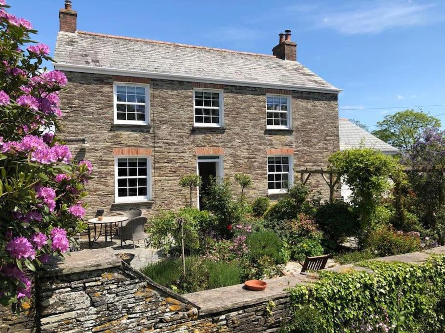 an old brick house with a garden in front of it at May House A beautiful Cornish holiday home in the heart of Cornwall in Wadebridge
