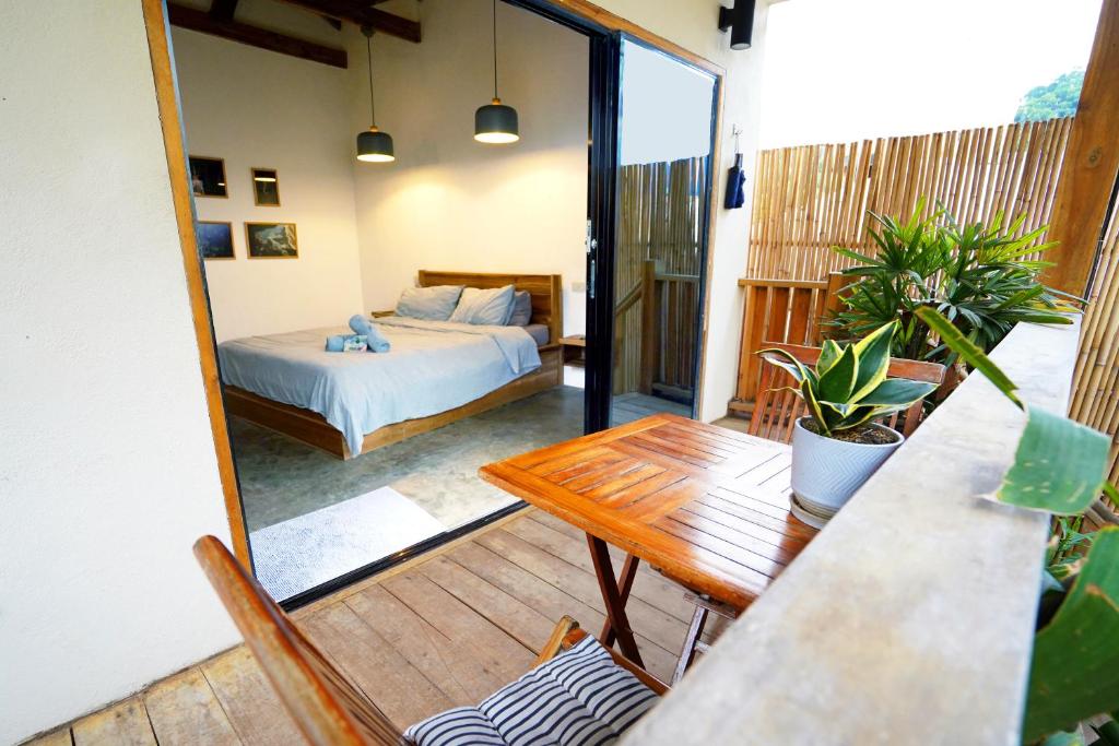 a bedroom with a bed and a table and a table sidx sidx at Fisheye The Rooms - Room 1 in El Nido