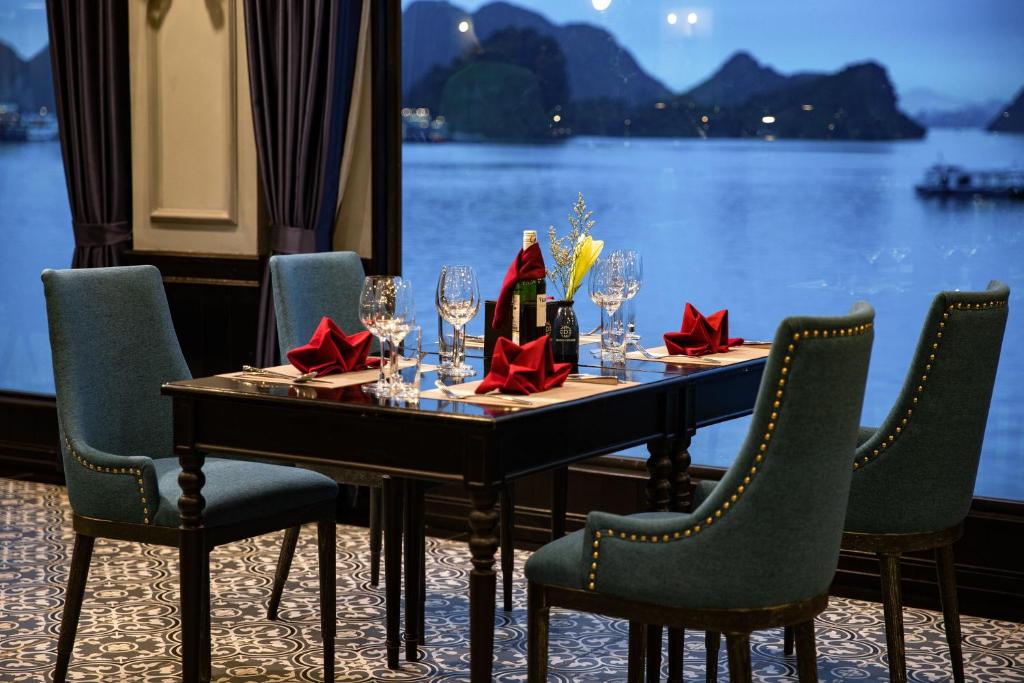 a table with wine glasses and red bows at Doris Cruise by HAG in Ha Long