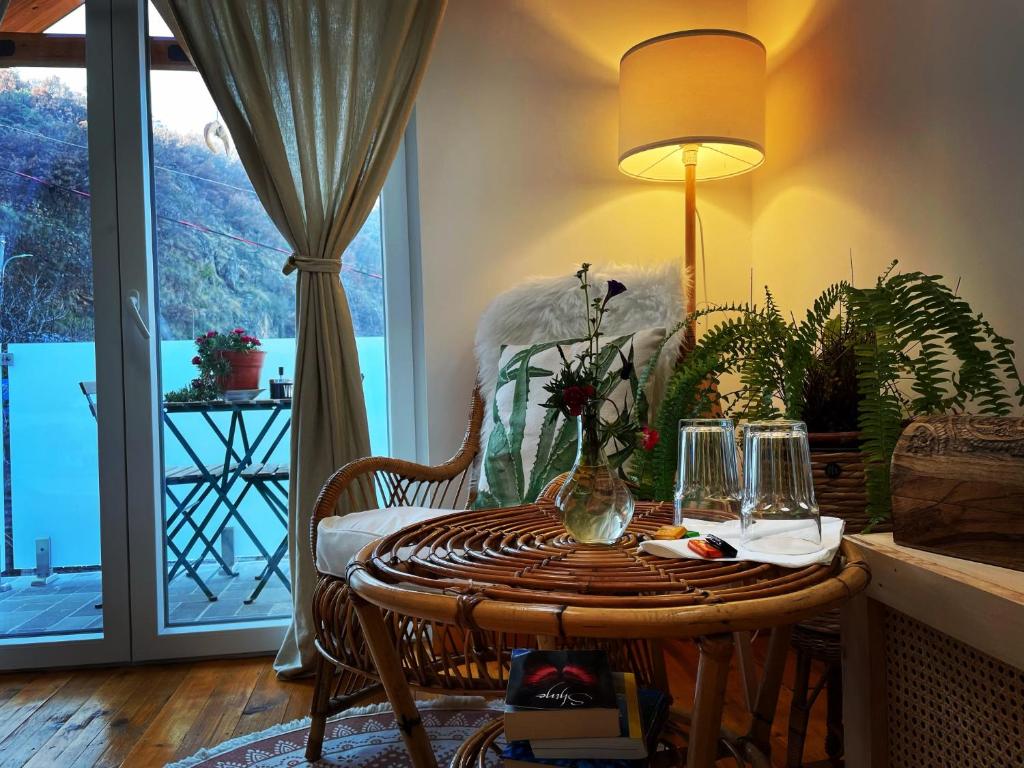 a room with a table with a lamp and a window at House 1960 in Lin