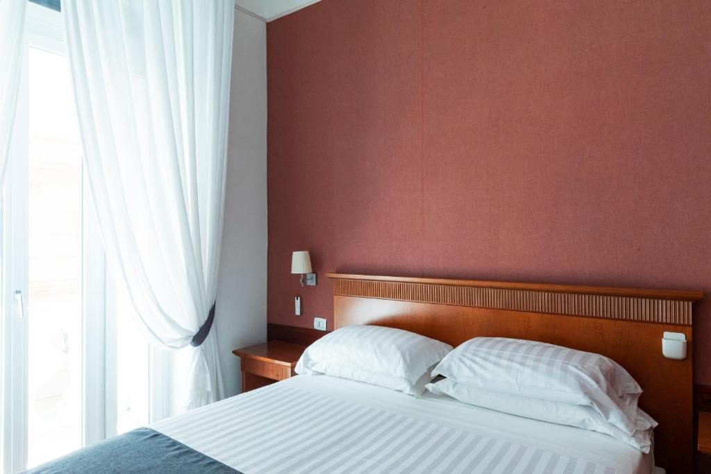 Postel nebo postele na pokoji v ubytování Rex Lifestyle Hotel