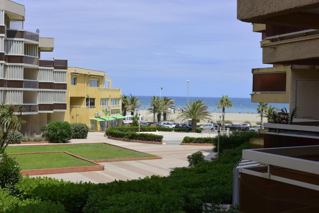 a view of the beach from the balcony of a building at Studio POP Canet En Roussillon in Canet-en-Roussillon