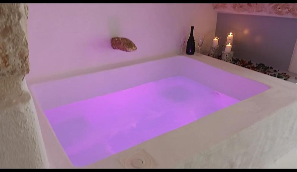 a white bath tub with purple lights in it at Lory's Luxury Suite Ostuni in Ostuni
