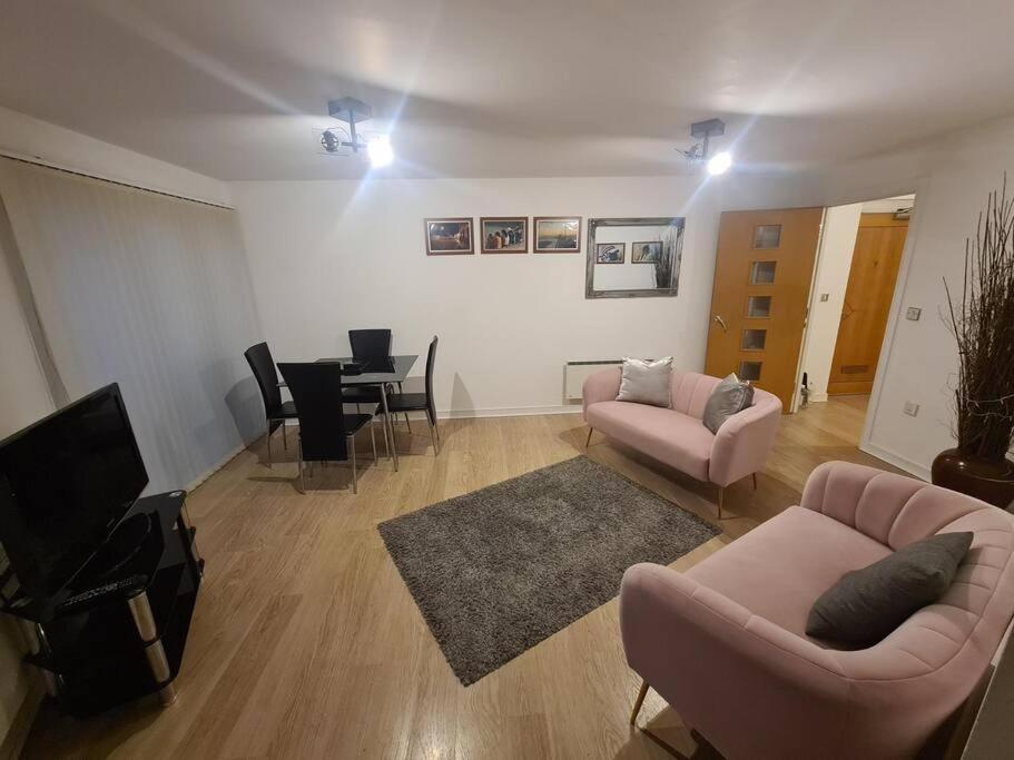 a living room with two couches and a table at 2 Bedroom 2 Bath Apartment, sleeps 4, Town Centre in Wolverhampton