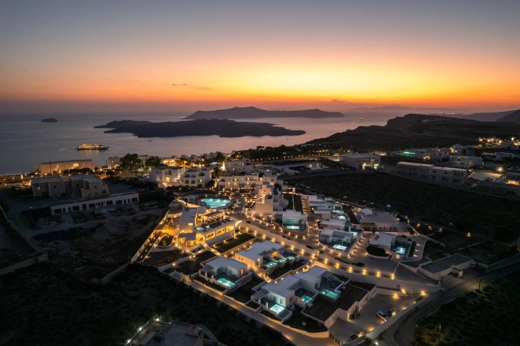 an aerial view of a city at night at De Sol Hotel & Spa in Fira