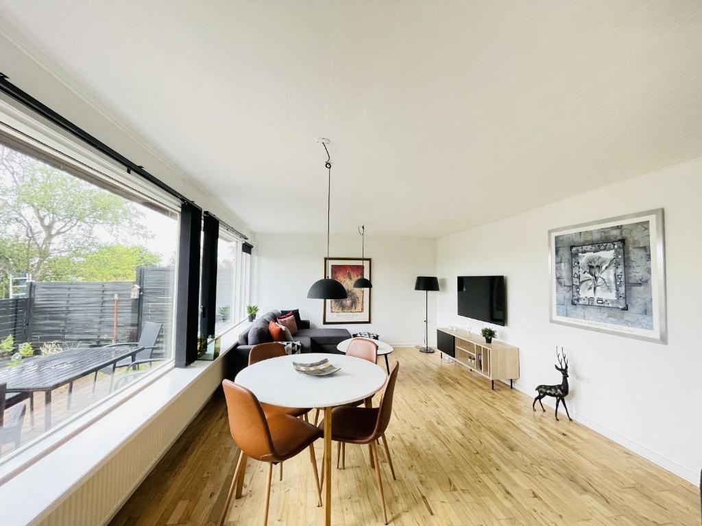 a living room with a table and chairs at aday - Quiet and cozy house in Aalborg