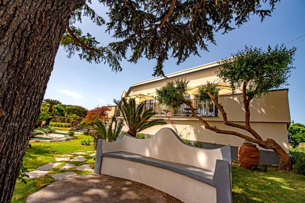 a white bench sitting in front of a building at Villa Barone in Procida