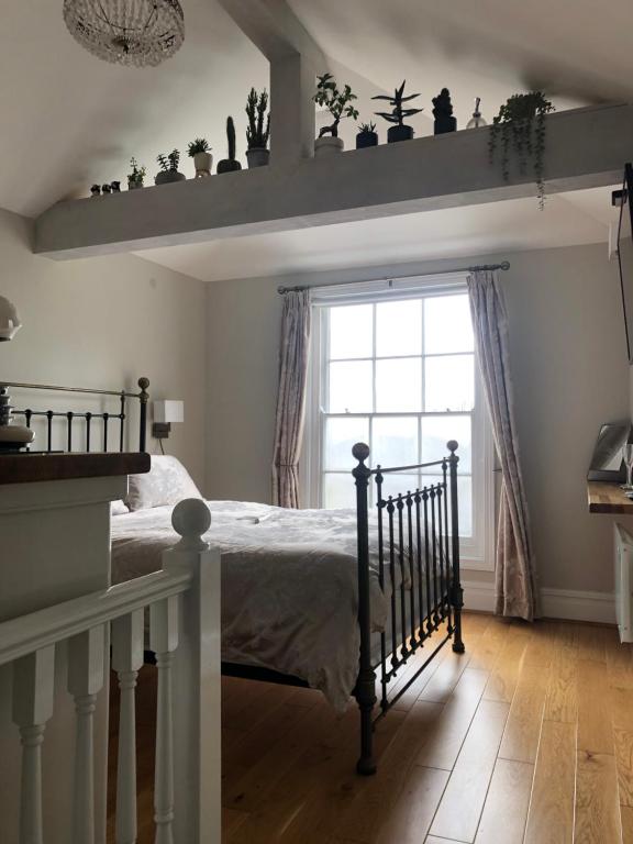 a bedroom with a bed and a window at The Beetroot in Margate
