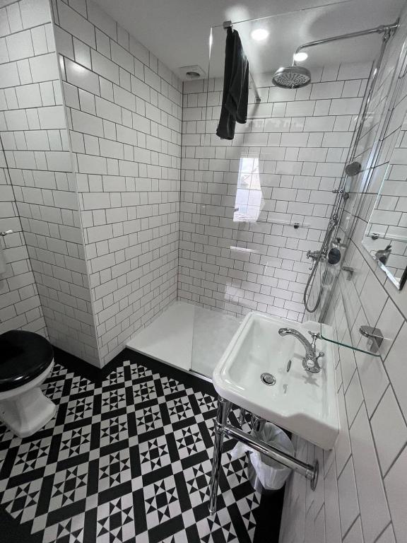 a white bathroom with a sink and a toilet at The Beetroot in Margate