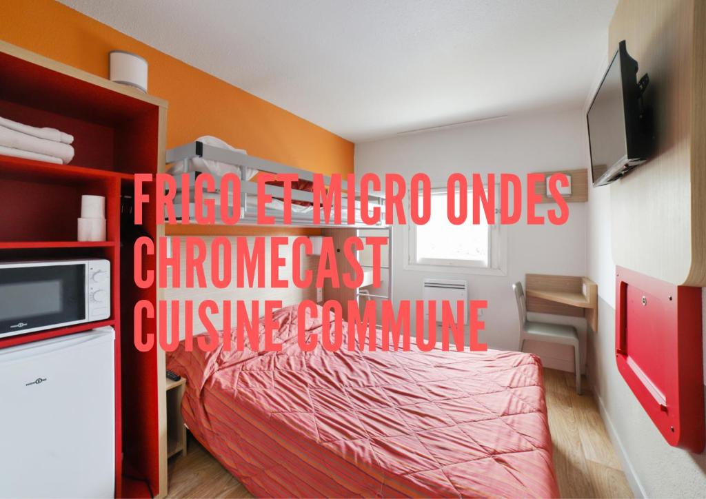 a bed room with a red bedspread and a red wall at Premiere Classe Paris Nord - Sarcelles in Sarcelles