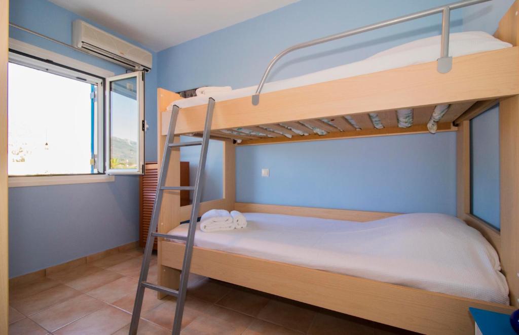 A bed or beds in a room at Laconian Collection ''Le Bleu Infini''