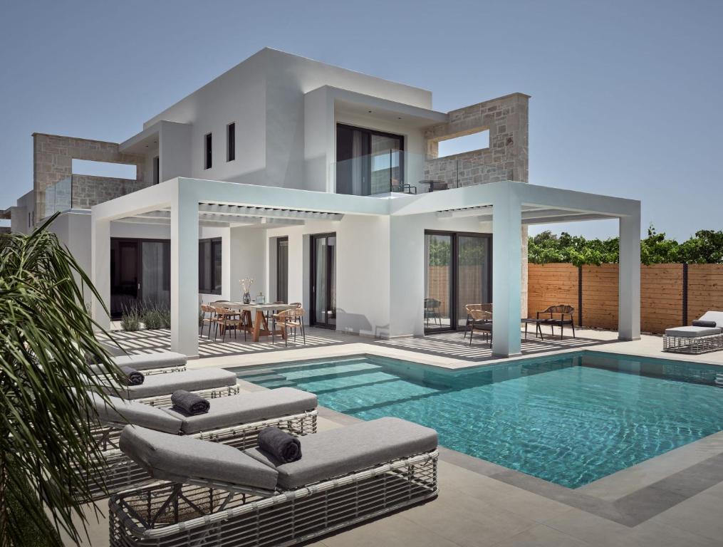 a villa with a swimming pool and a house at Anthis Luxury Villa in Zakynthos Town