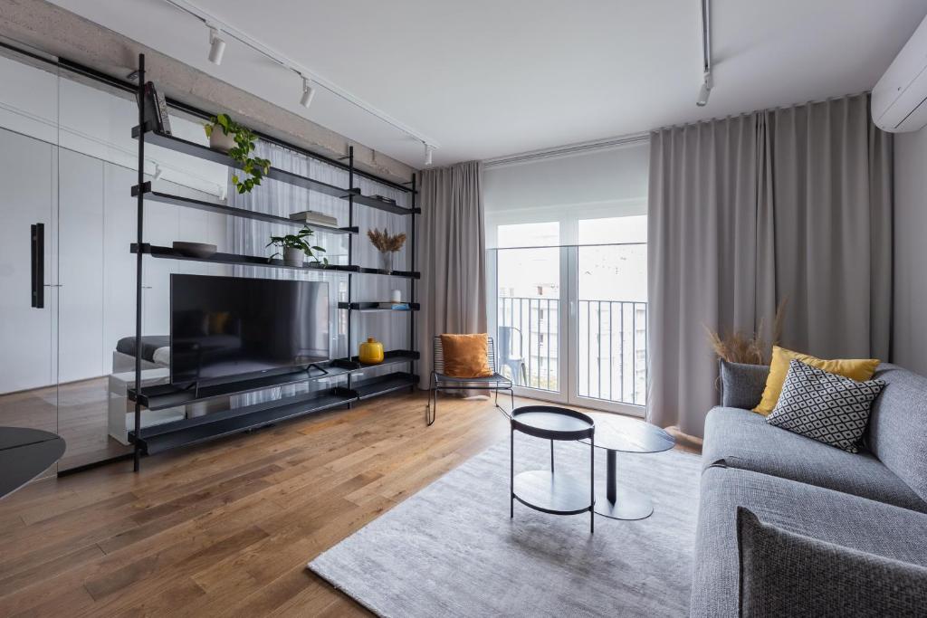 a living room with a couch and a tv at Odra Apartments in Wrocław