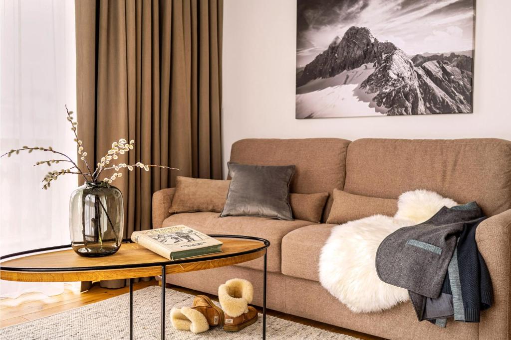 a living room with a couch and a table at Dependance Dachsteinperle in Ramsau am Dachstein